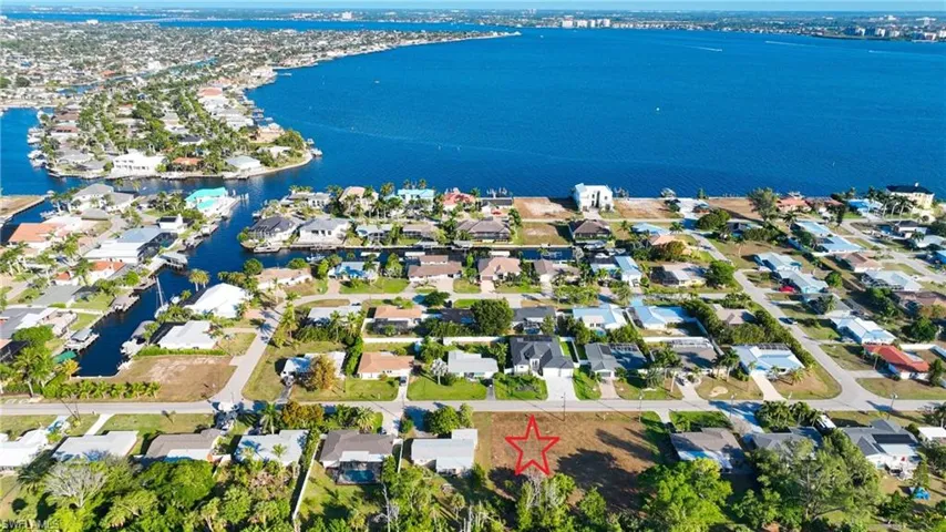 Aerial perspective of suburban area with a nearby body of water