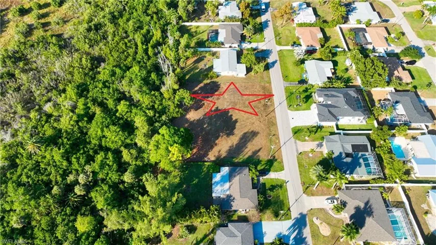 Aerial view of residential area with property parcel outlined