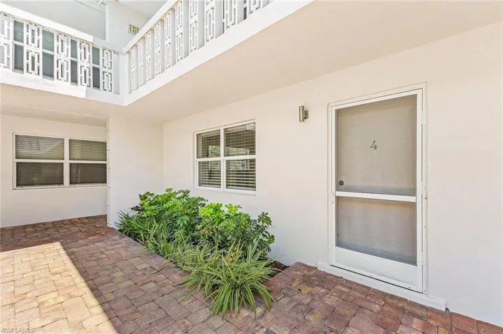 View of exterior entry with a patio area and stucco siding