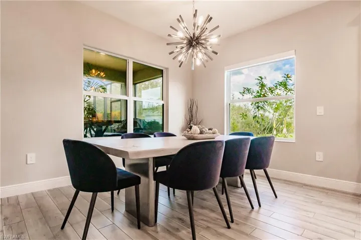 Dining area featuring a chandelier, plenty of natural light, and light wood-type flooring