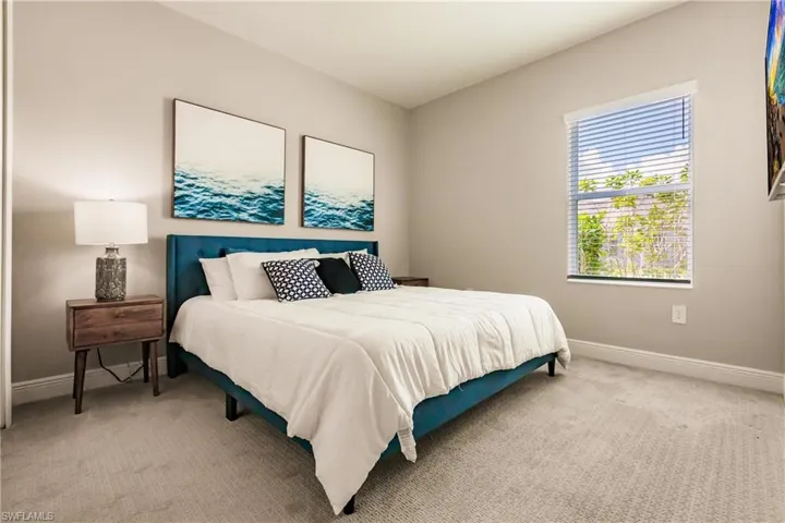 Bedroom featuring carpet flooring and baseboards