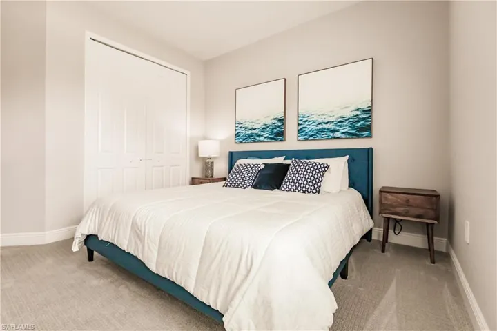 Bedroom featuring light carpet and a closet