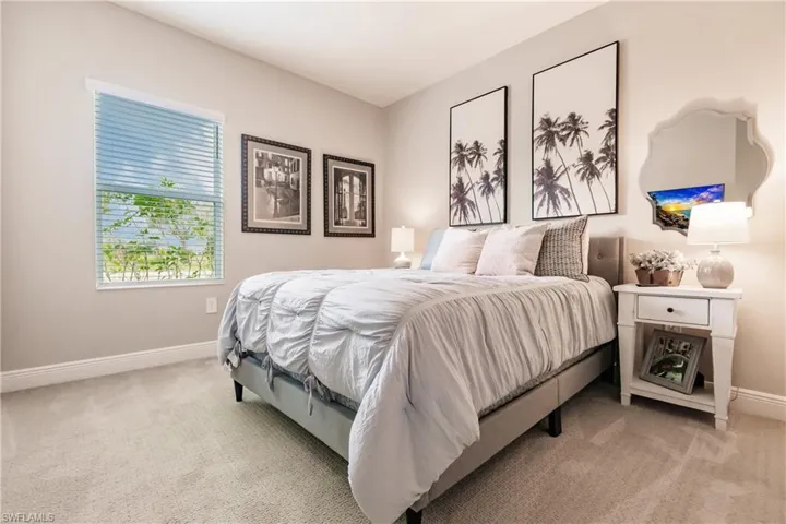 Bedroom featuring light colored carpet