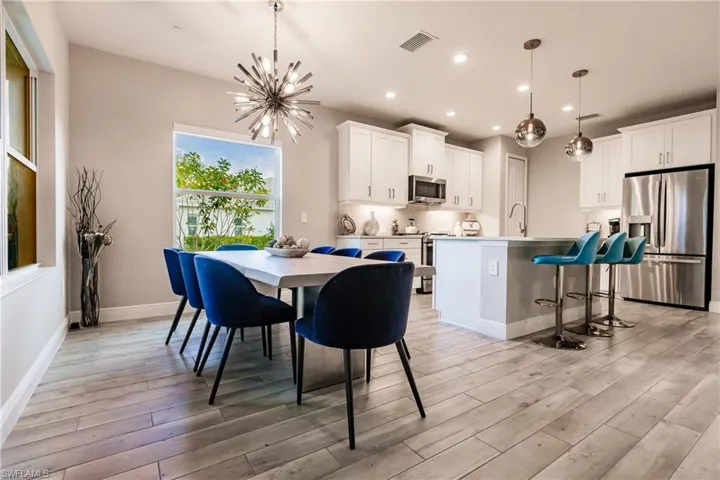 Dining space with a chandelier, recessed lighting, and light wood-type flooring