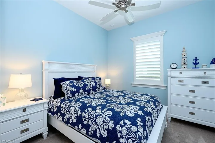 Carpeted bedroom with ceiling fan
