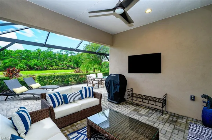 View of patio / terrace with ceiling fan, an outdoor hangout area, and a lanai