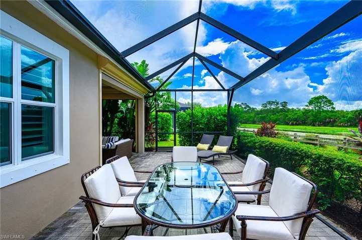 View of patio with outdoor lounge area and a lanai