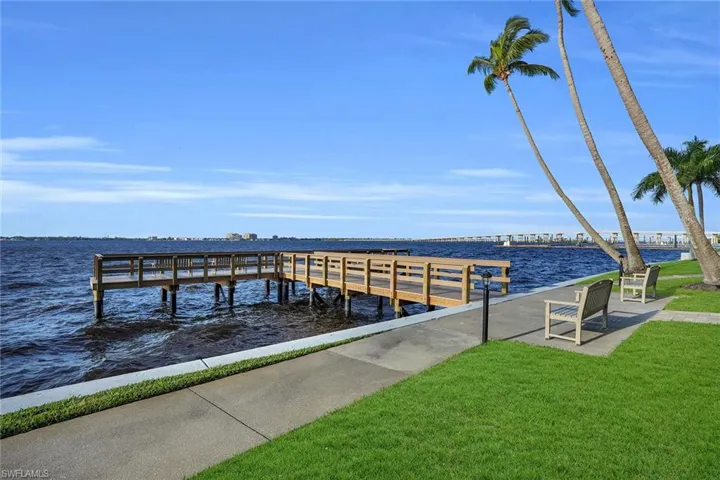 Dock with a water view and a yard