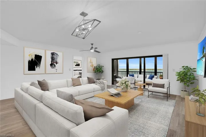 Living room featuring wood finished floors, ceiling fan, ornamental molding, and a water view **PHOTO IS VIRTUALLY STAGED**