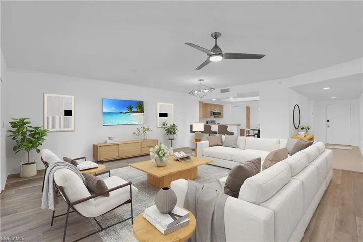 Living area featuring light wood-type flooring, a ceiling fan, and recessed lighting **PHOTO IS VIRTUALLY STAGED**