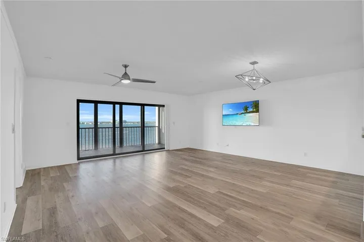 Spare room with light wood-style floors and a ceiling fan