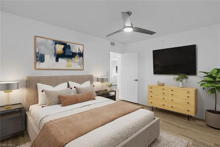 Bedroom with wood finished floors and a ceiling fan **PHOTO IS VIRTUALLY STAGED**
