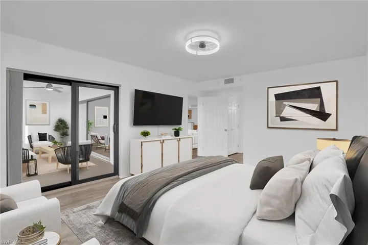 Bedroom featuring wood finished floors and access to exterior **PHOTO IS VIRTUALLY STAGED**