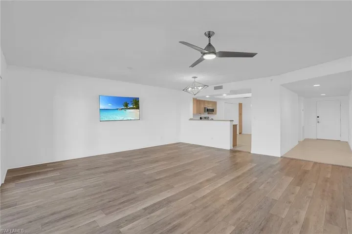 Unfurnished living room with light wood finished floors, ceiling fan, and recessed lighting
