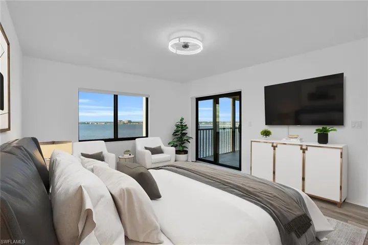 Bedroom with access to exterior and light wood-style flooring **PHOTO IS VIRTUALLY STAGED**