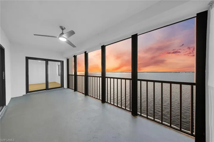 Unfurnished sunroom with a water view