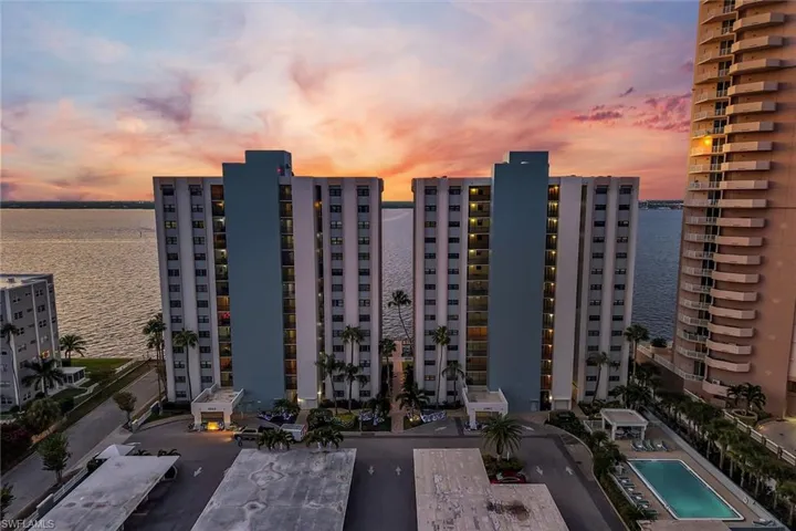 View of apartment building / complex featuring a water view