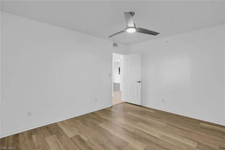Unfurnished bedroom with a ceiling fan and light wood-style flooring