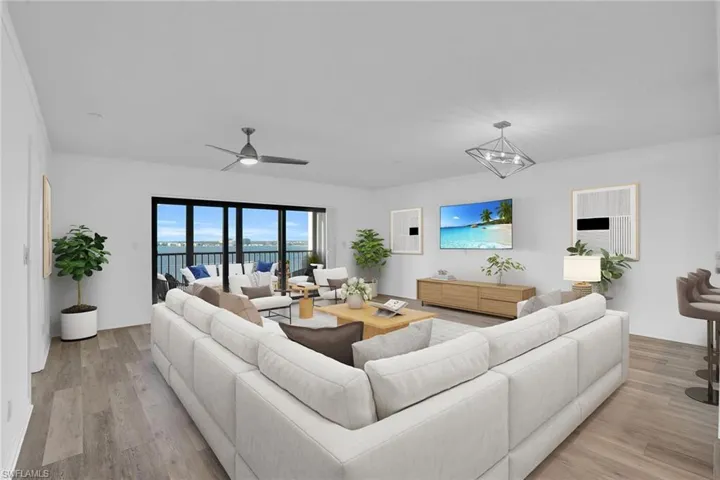 Living area with light wood-style flooring and a ceiling fan **PHOTO IS VIRTUALLY STAGED**