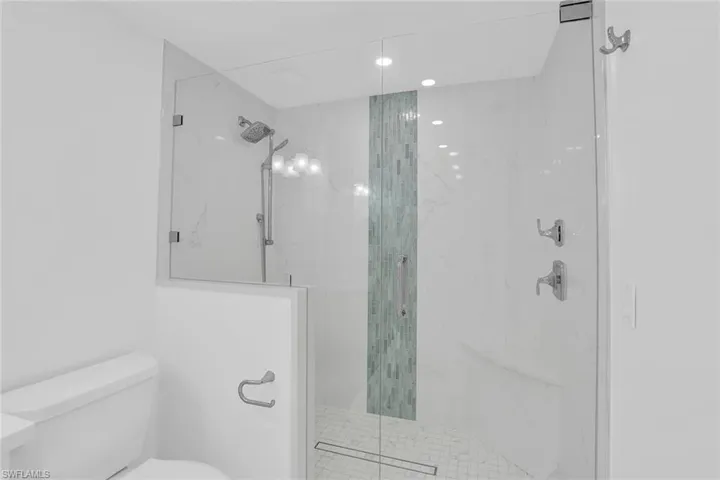 Bathroom featuring a marble finish shower