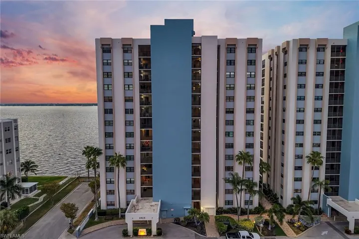 View of apartment building / complex featuring a water view