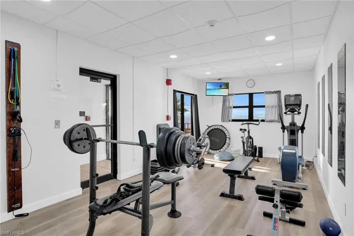 Exercise area featuring a drop ceiling and recessed lighting