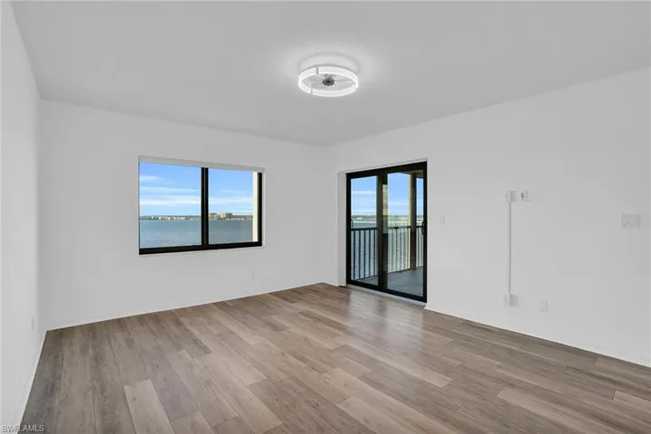 Unfurnished room featuring light wood-style flooring and a water view