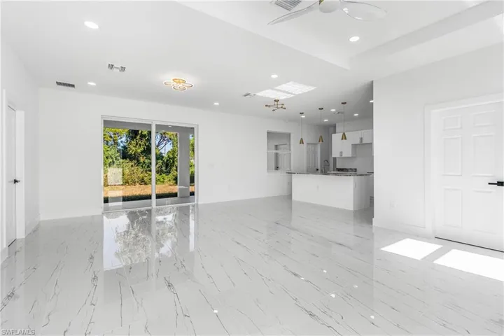 Unfurnished living room featuring ceiling fan and recessed lighting