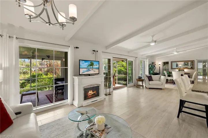 Living room featuring plenty of natural light, a chandelier, and light wood finished floors