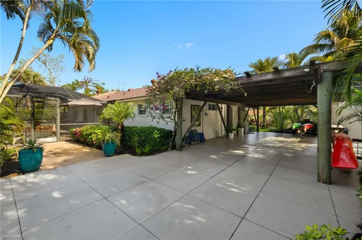 View of front of home featuring a lanai, stucco siding, and an attached carport