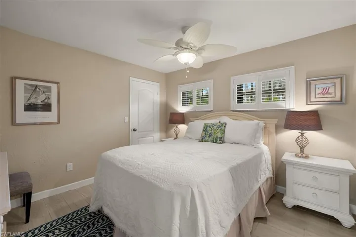 Bedroom with light wood-style floors and a ceiling fan