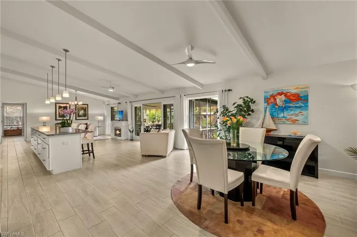 Dining space with ceiling fan and light wood-type flooring