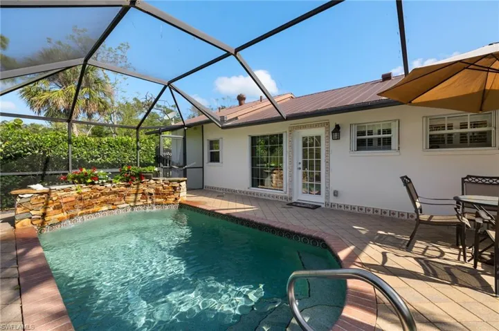 Outdoor pool with a lanai, a sunroom, and a deck