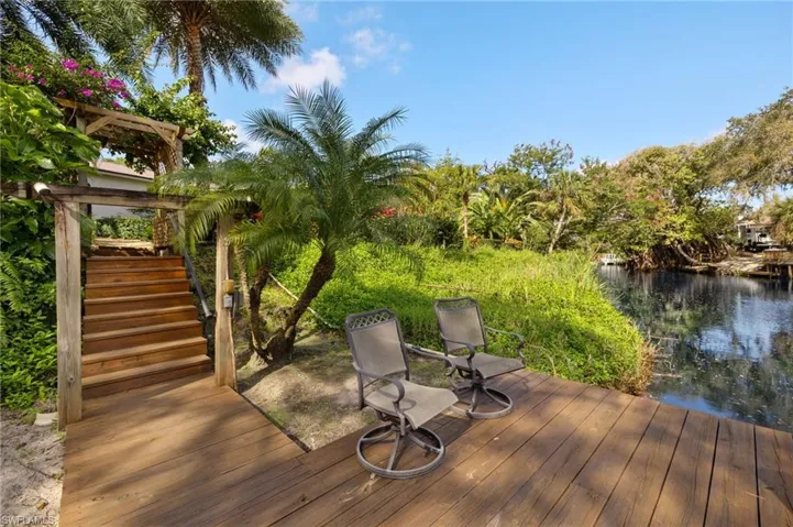Wooden terrace with stairs and a water view