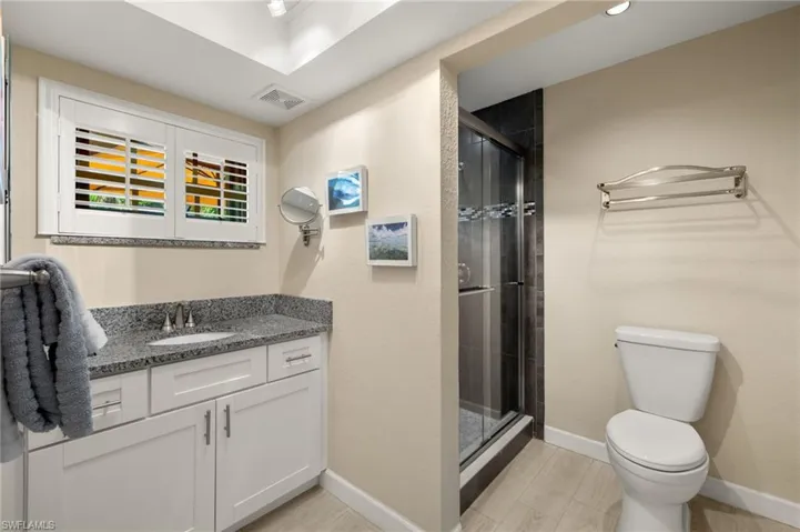 Full bath with vanity and a shower stall