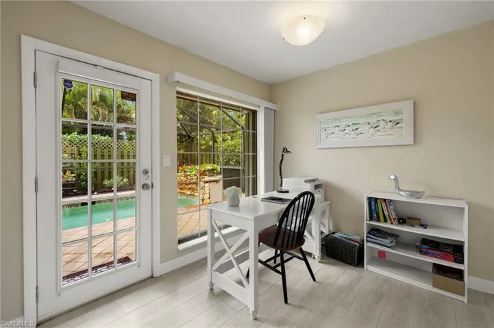 Office with light wood-style floors and baseboards