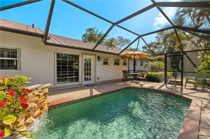 Swimming pool with a patio, a lanai, and a sunroom