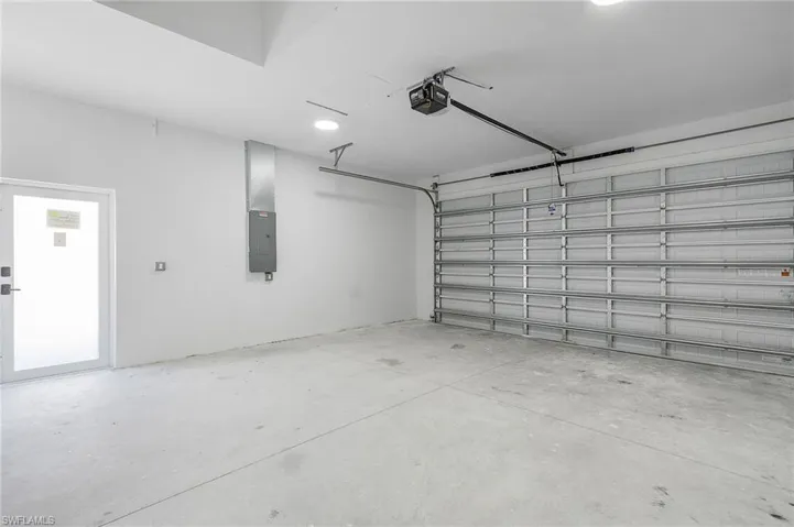 Garage with a garage door opener and electric panel