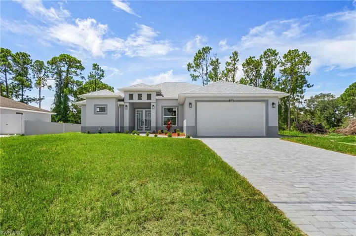 View of front of home featuring a garage and a front yard