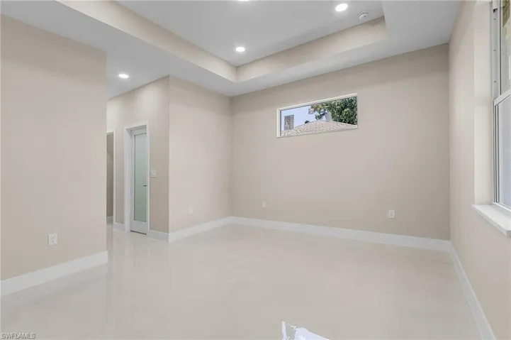 Spare room featuring a raised ceiling and light tile patterned floors