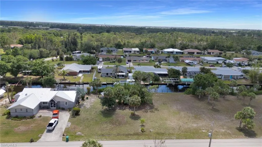 Drone / aerial view featuring a residential view, a wooded view, and a water view