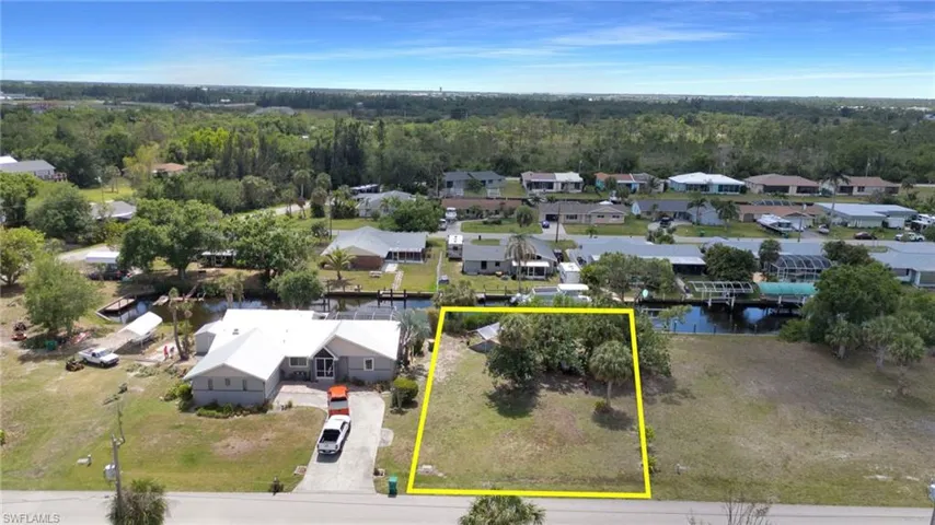 Drone / aerial view with a forest view, a water view, and a residential view