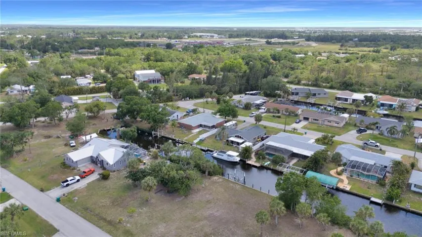 Drone / aerial view with a residential view and a water view