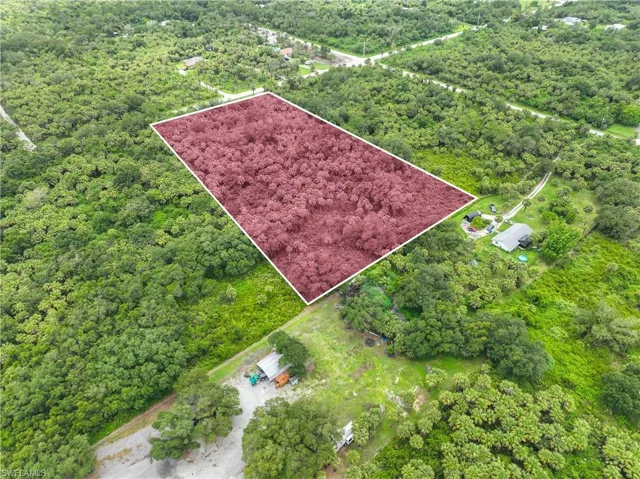 Aerial view of property's location with property boundaries highlighted and a forest