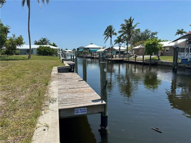 Dock area featuring a lawn and a water view