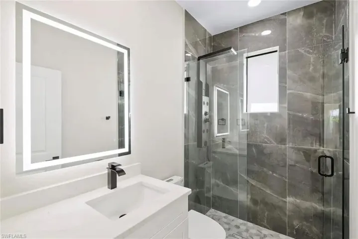 Bathroom with vanity and a stall shower