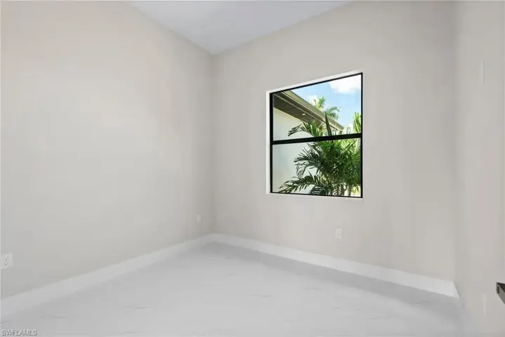 Unfurnished room featuring baseboards and light marble finish floors