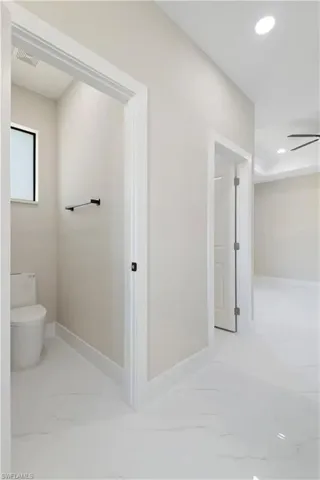 Bathroom featuring light marble finish floors, recessed lighting, and a ceiling fan