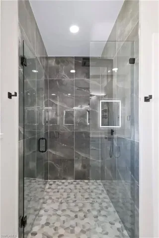 Full bathroom with a shower stall and recessed lighting