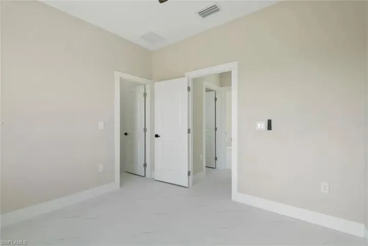 Spare room with light marble finish flooring
